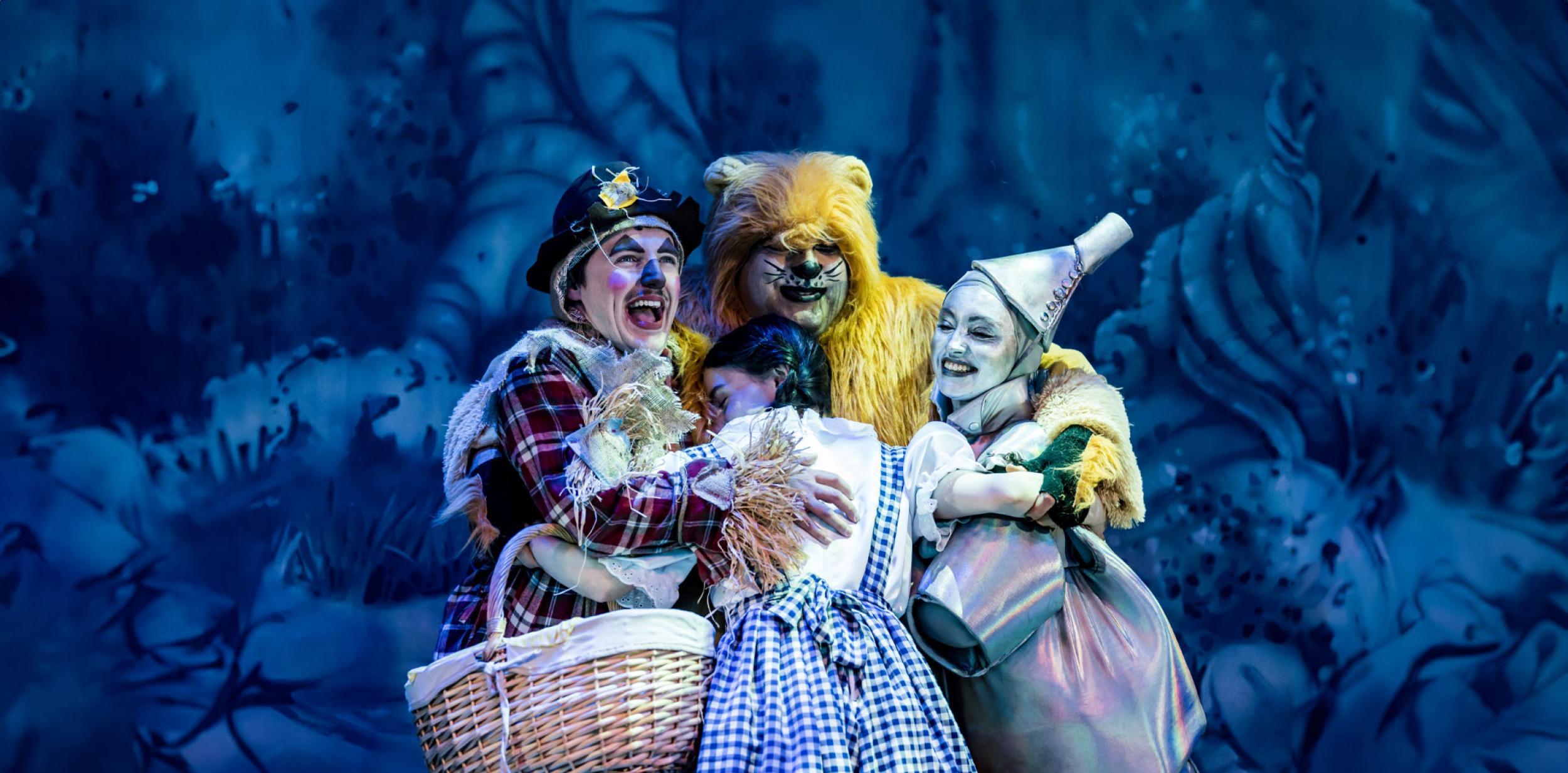 Pantomime characters having a group hug